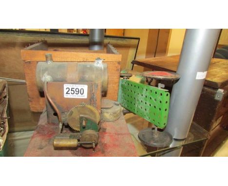 A model steam engine in a wooden box,