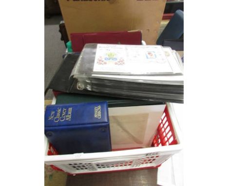 A crate of commemorative and first day covers including Royal Mail album of Millenium stamps and FDC's.