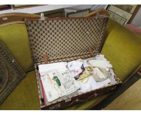 A large vintage suitcase of vintage linens, knitting, sewing, needlecraft patterns, handkerchiefs, gloves etc., COLLECT ONLY.