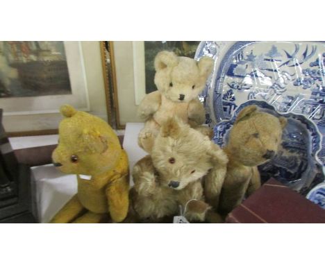 Four vintage teddy bears.