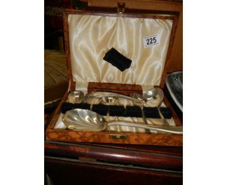 A cased dessert set and a ladle. (missing one spoon).