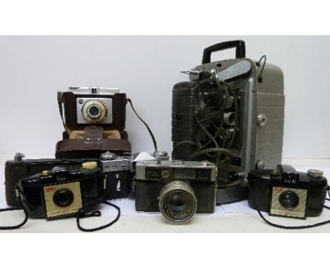 A Bell & Howell Moviemaster, a Zenit E camera body, an Ilford Sporti camera, an Acima Eyelux camera, a Kodak box camera, etc.