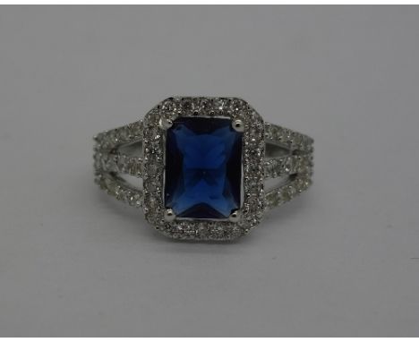 A silver ring set with synthetic sapphire, size M
