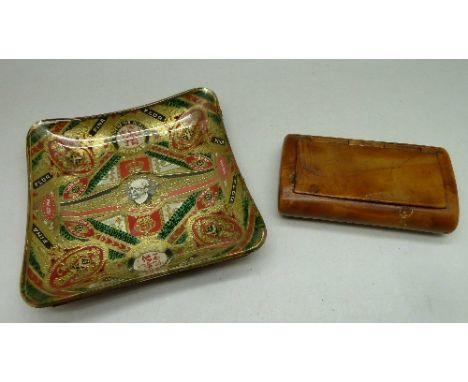 A snuff box and glass ashtray with cigar label decoration