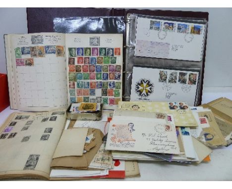 A collection of stamps and an album of first day covers
