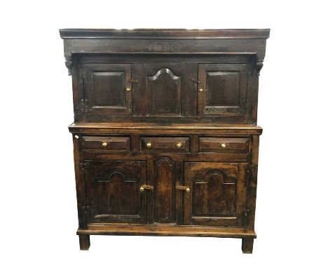 A large 18th century and later oak food cupboard or dudarn, the frieze dated centrally '1716', over a pair of hinged panelled