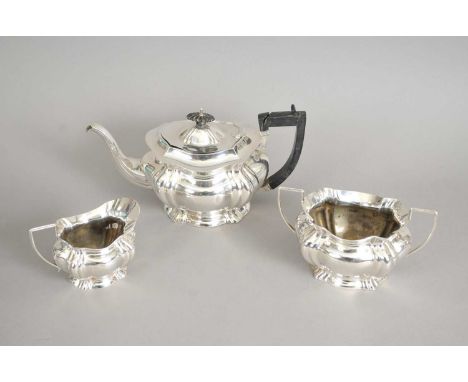 A three piece silver tea service, Fraget &amp; Co, Birmingham 1908, each of shaped oval form, comprising; a teapot with eboni