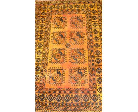 An eastern wool rug, with a central rectangular panel enclosing eight further smaller panels, 172 x 108 cm.