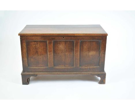 A George III country oak mule chest, with a hinged panelled top and panelled front and sides, raised on shaped bracket suppor