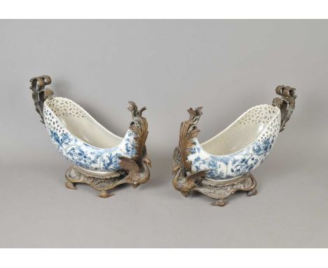 A decorative pair of cast metal mounted blue and white ceramic boats, with pierced bowls, stamped to undersides, 31 cm high.