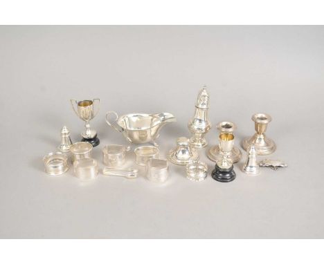 A silver sauce boat, Mappin &amp; Webb, Sheffield 1937, together with a collection of seven silver napkin rings, two miniatur