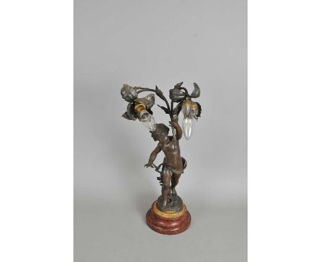 A French bronzed spelter figural desk lamp, 'La Foret par Ferrand' over a red marble socle base, signed to ground, with appli