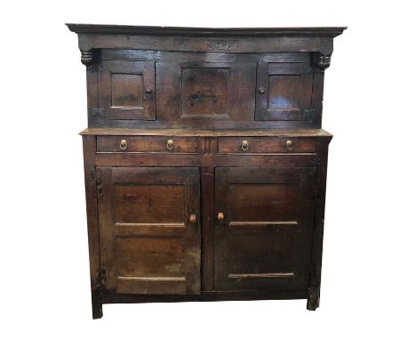 An early 18th century oak court cupboard dated '1727' and initialled 'K', 148 cm wide x 60 cm deep and 173 cm high.