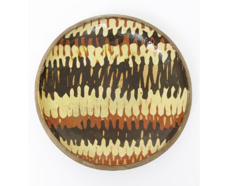 Bernard Leach (1887-1979) attributed a Leach Pottery slipware dish, with combed brown and cream decoration, impressed Leach P