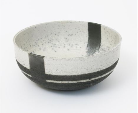 ‡ Robin Welch (born 1936) a raku pottery bowl, burnished black with resist decorated crackled and speckled white glaze, impre