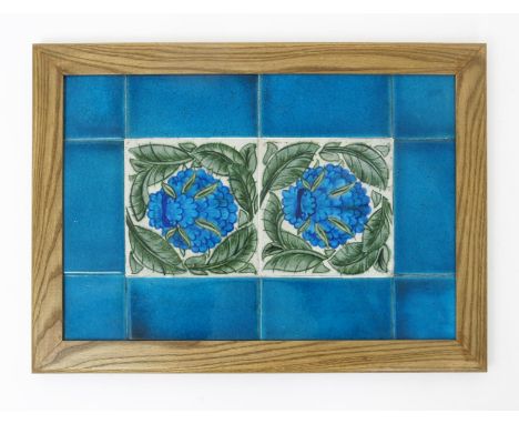 A William De Morgan Cavendish two tile panel, painted in shades of blue and green on a white ground, set inside turquoise bor