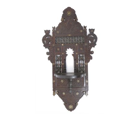 An Anglo Moorish wall shelf unit, possibly retailed by Liberty & Co,  pierced and carved with foliate and Arabic panels, inse