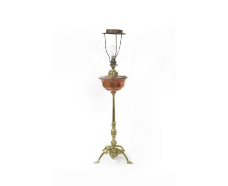 A W.A.S Benson brass and copper table lamp,  the arched tripod foot cast with foliate stems and ball counterweight, supportin