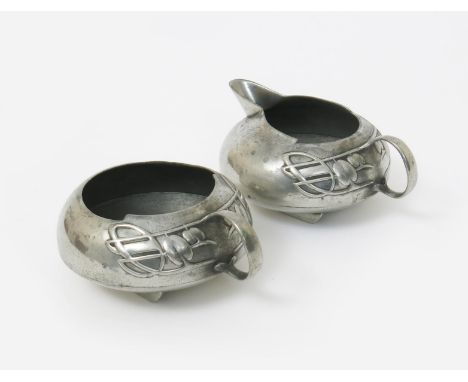 An Art Nouveau Liberty & Co English Pewter sugar basin and milk-jug designed by Archibald Knox, model no.0231, streamlined fo