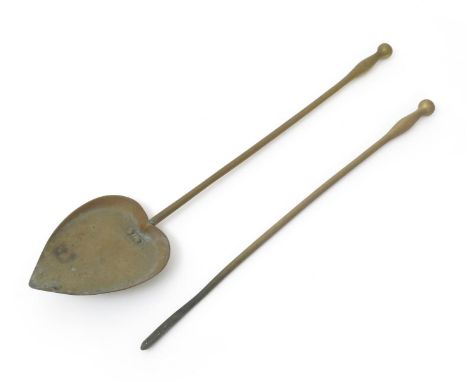 A cast brass coal shovel and poker designed by C.F.A. Voysey, probably manufactured by Thomas Elsley Ltd, with heart shaped s