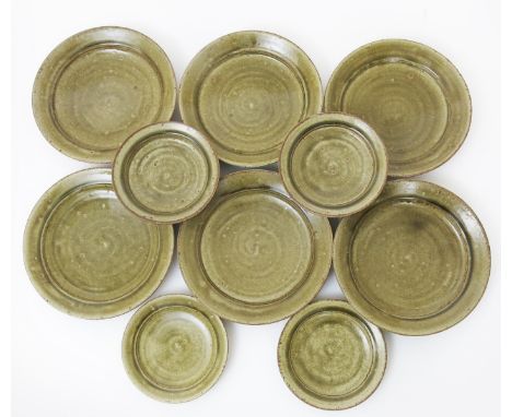 Richard Batterham (born 1936) a stoneware service, comprising, twelve dinner and side plates, covered in ash glaze unsigned,d