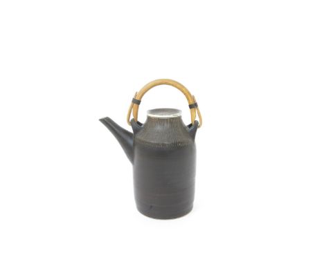 ‡ Dame Lucie Rie DBE (1902-1995) a stoneware coffee pot and cover, sgraffito lines in manganese to the cover and side on a gr