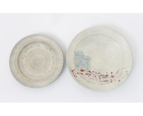 Robin Welch (born 1936) a raku pottery charger, glazed white with painted red and pale blue abstract design, and another smal