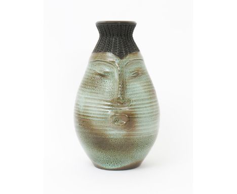 A rare Poole Pottery Atlantis vase by Guy Sydenham,  tapering pear shaped body, modelled with a stylised face, glazed in gree