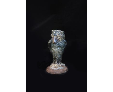 A Martin Brothers stoneware bird jar and cover designed by Robert Wallace Martin, the bird with piercing staring eyes, his wi