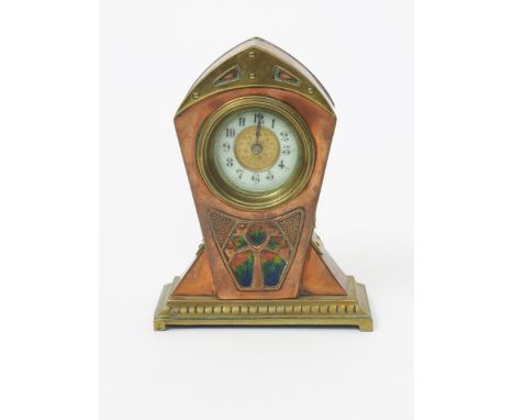 A continental Secessionist copper and brass mantel clock, angular form with cast strap decoration and stylised foliate panel 