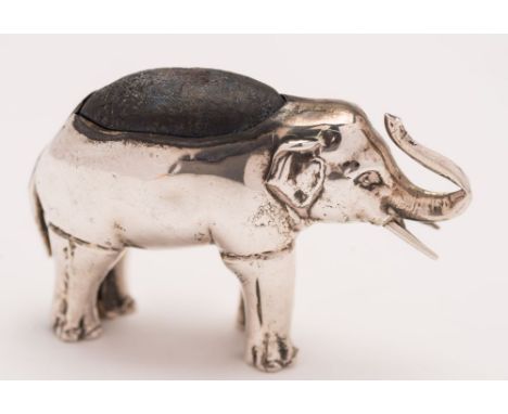 An Edward VII silver novelty pin cushion in the form of an elephant, maker's mark worn, Birmingham, 1905: with raised trunk, 