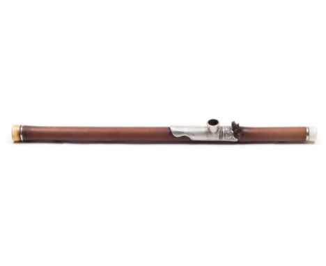 An early 19th century bamboo,  ivory and white metal opium pipe: the mount with panel decorated with foliage, 61cm. long.