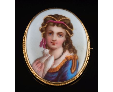 An enamelled porcelain panel brooch: depicting a young woman holding a dove in a 9ct gold frame, 49mm long.