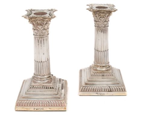 A pair of Edward VII silver desk candlesticks, maker William Hutton & Sons Ltd, London, 1902: with gadrooned drip trays, Cori