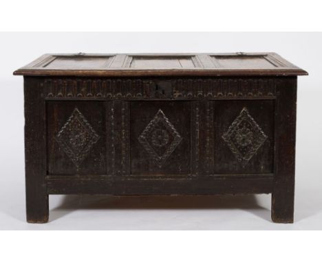 An 18th century oak rectangular coffer: with a hinged moulded panel top, the front with a fluted frieze and triple lozenge go