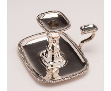 An Edward VII silver chamber stick, maker Goldsmiths & Silversmiths Co Ltd, London, 1909: with rectangular urn-shaped nozzle 