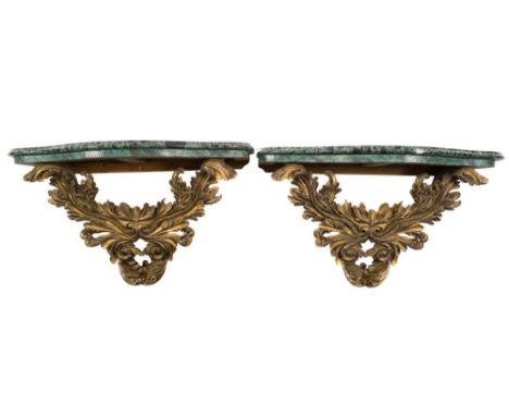 A pair of carved giltwood acanthus scroll decorated console brackets:, each surmounted by a serpentine fronted panel of green