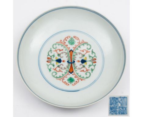 A Chinese doucai saucer dish: painted with a ring-tied foliate medallion within double circles, the reverse with foliate and 