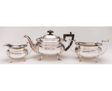 A George V silver three-piece tea service, maker John & William Deakin, Sheffield, 1934: of barge -shaped outline, with gadro