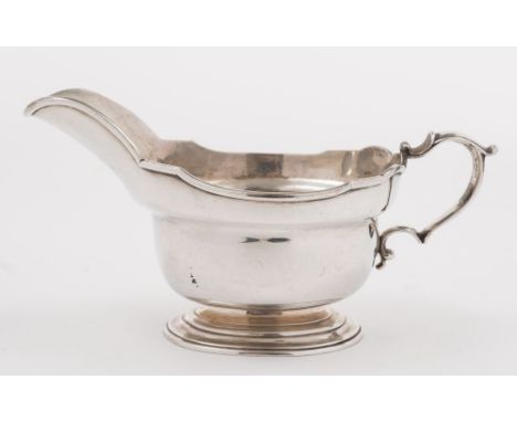 A George V silver pedestal sauce boat, maker J S Harman, London, 1925: with moulded rim and scroll handle on an oval spreadin