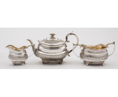 A George III silver matched three-piece tea service. various makers, London, 1805,1816 and 1819: with half-reeded decoration,