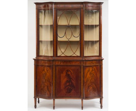 An Edwardian mahogany and inlaid display cabinet: of shaped front outline, crossbanded in satinwood, bordered with boxwood, e