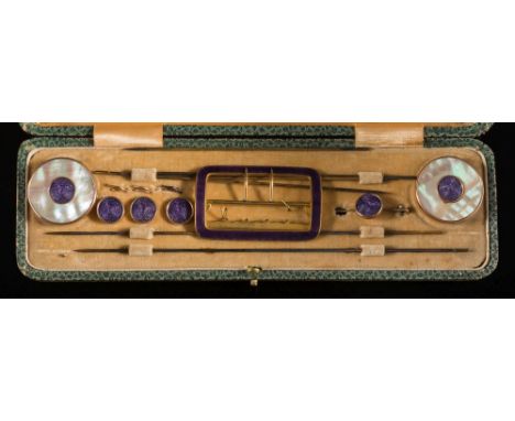An Edwardian gilt-metal and purple enamel dressing set: comprising hat pins with two circular mother of pearl and purple enam