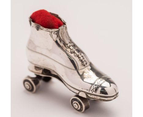 An Edward VII novelty pin cushion in the form of a roller skate, maker Crisford & Norris Ltd, Birmingham 1909: 7cm. long.