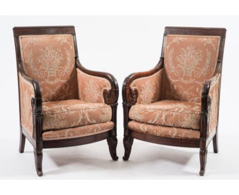 A pair of French 'Restauration' mahogany fauteuils:, the upholstered panel backs with plain top rails, upholstered scroll arm