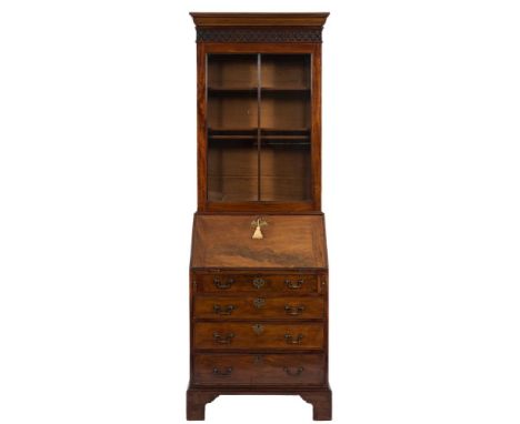 A George III mahogany bureau bookcase:, of small size, the upper part with a cushion moulded cornice and blind fret carved ge