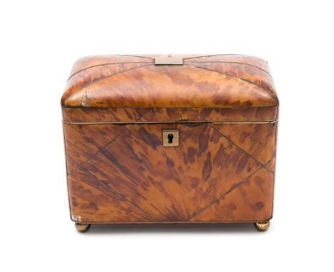 An early 19th century blonde tortoiseshell tea caddy: the shallow domed hinged top enclosing two lidded compartments containi