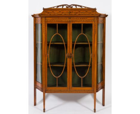 An Edwardian satinwood, inlaid and decorated display cabinet:, of canted outline, crossbanded in kingwood, bordered with boxw