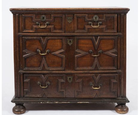 A 17th Century oak rectangular chest:, the top with a moulded edge, containing two short and two long geometrically moulded p