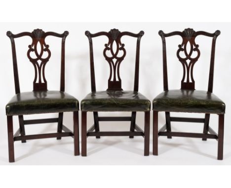 A set of six George III carved mahogany dining chairs in the Chippendale taste:, the backs with serpentine top rails with flo